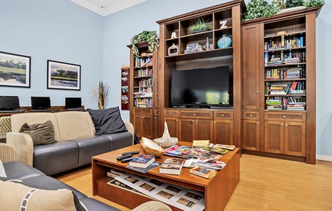 a living room with a couch and a coffee table and a television